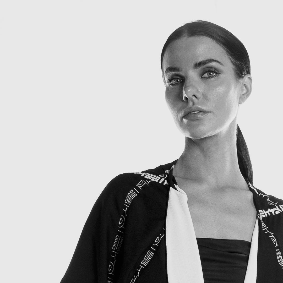 Black and white portrait of a woman wearing a pattern Dubai abaya.